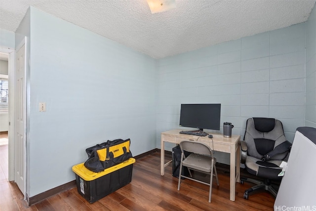 office space with a textured ceiling and dark hardwood / wood-style flooring