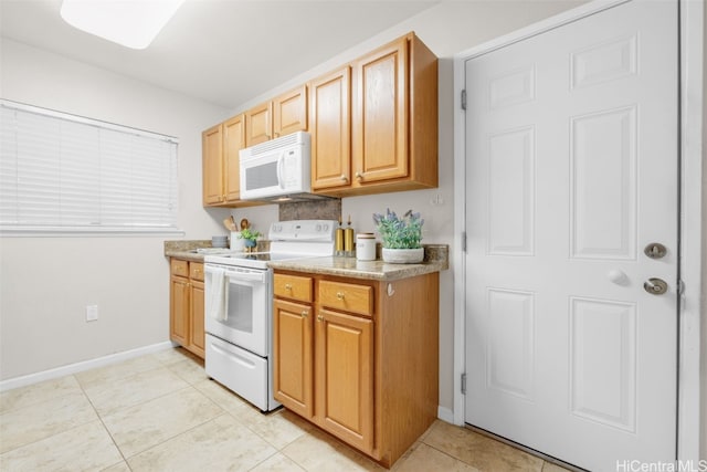 kitchen with white appliances and light tile patterned floors