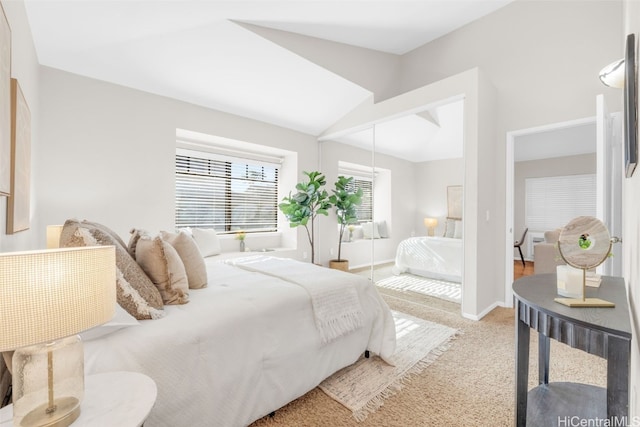 carpeted bedroom featuring a closet and vaulted ceiling