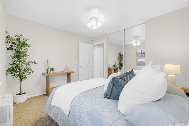 bedroom with a closet and light colored carpet