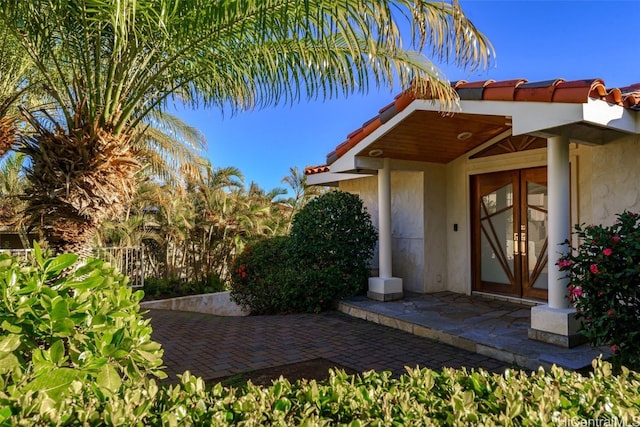 view of exterior entry featuring french doors