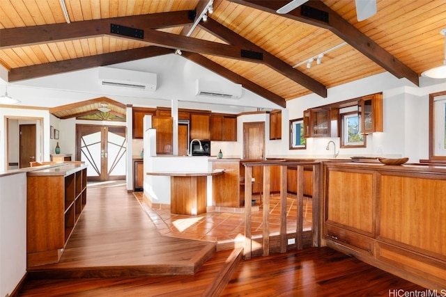 kitchen with beamed ceiling, dark hardwood / wood-style floors, an AC wall unit, and wood ceiling