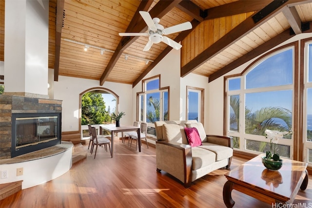 living room with beamed ceiling, hardwood / wood-style floors, high vaulted ceiling, and wood ceiling