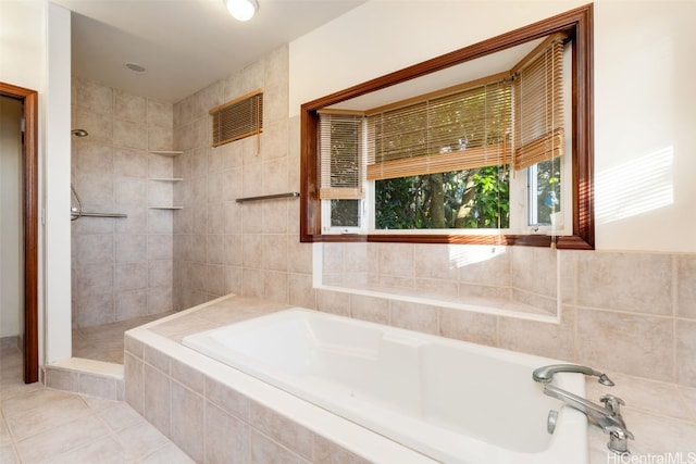 bathroom featuring tile patterned flooring and plus walk in shower