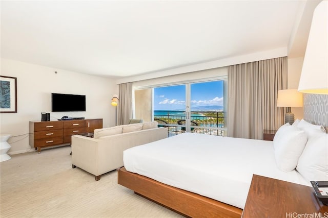 bedroom featuring access to exterior and light colored carpet