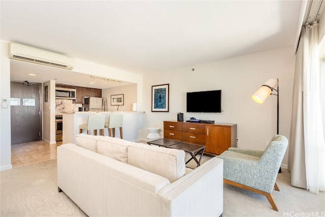 living room featuring an AC wall unit and rail lighting