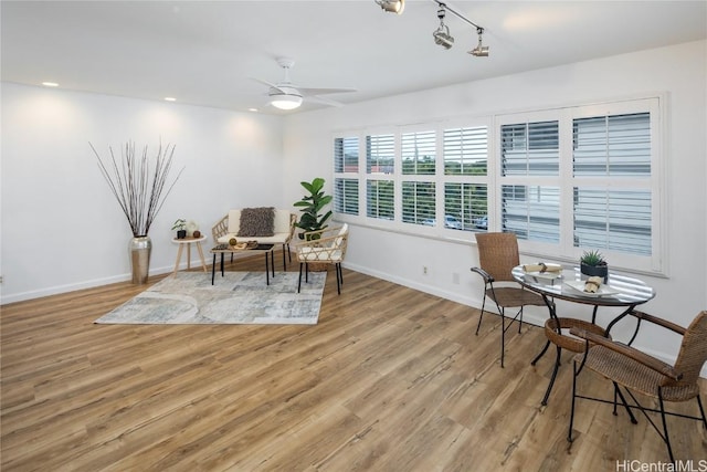 living area with ceiling fan and hardwood / wood-style floors