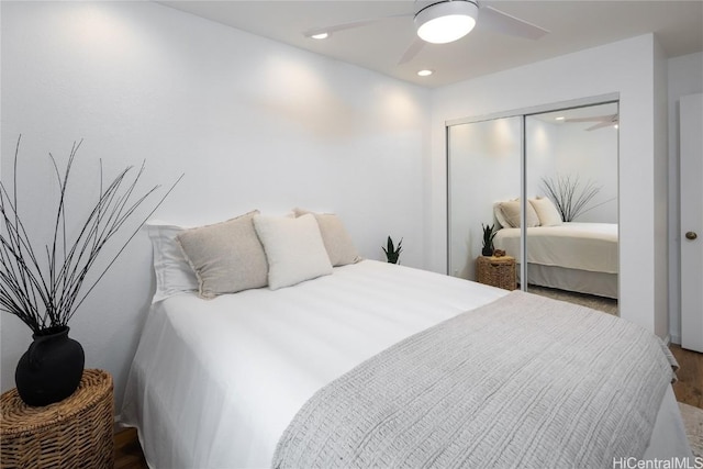 bedroom featuring ceiling fan, a closet, and wood-type flooring