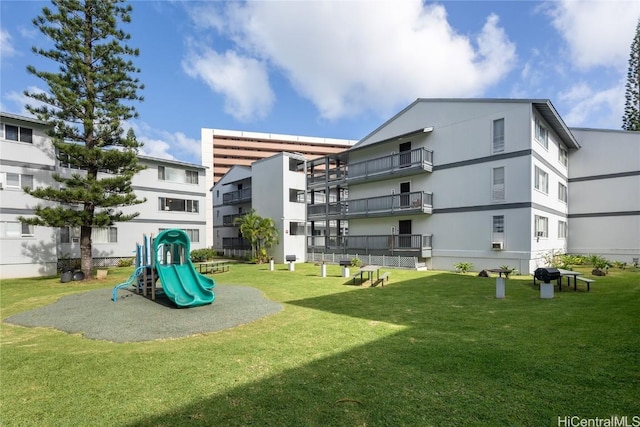 back of property with a playground and a lawn