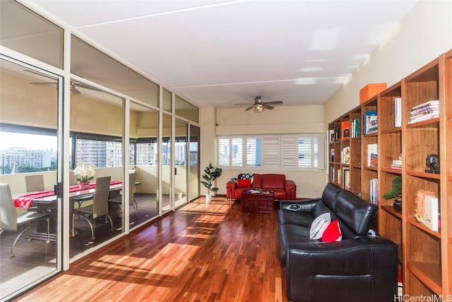 living area featuring hardwood / wood-style flooring, ceiling fan, and a healthy amount of sunlight