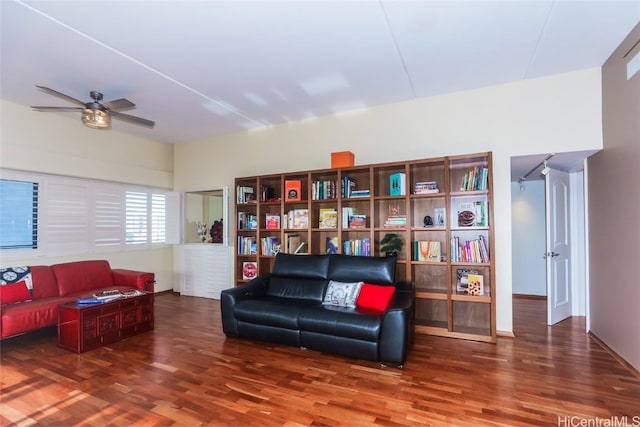 living area with dark hardwood / wood-style floors and ceiling fan