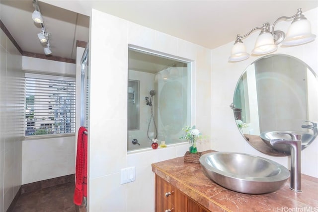 bathroom with vanity and tile walls