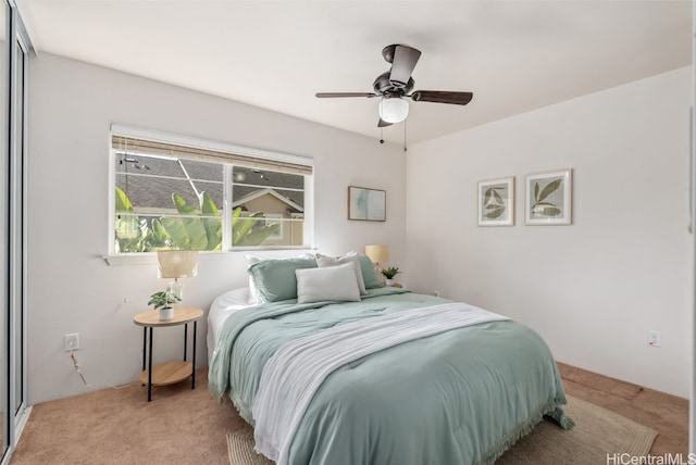 bedroom featuring light carpet and ceiling fan