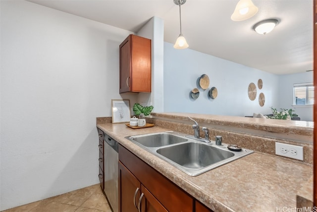 kitchen with pendant lighting, stainless steel dishwasher, light tile patterned floors, and sink