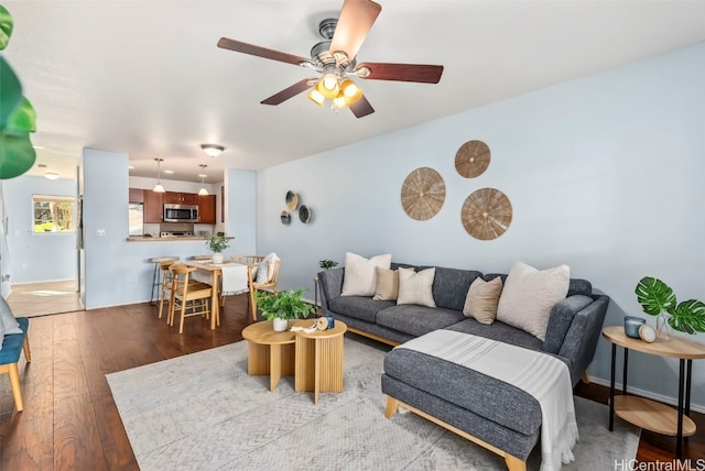 living room featuring light hardwood / wood-style floors and ceiling fan