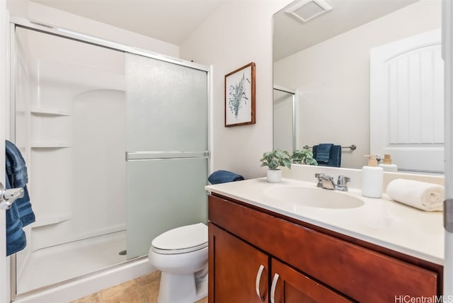 bathroom featuring tile patterned floors, vanity, toilet, and a shower with shower door