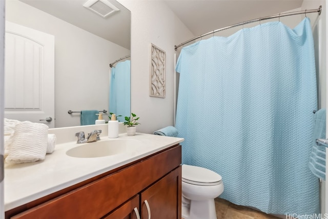 bathroom featuring tile patterned floors, vanity, and toilet