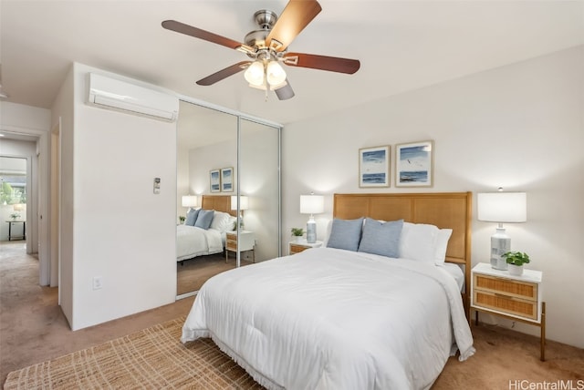 bedroom featuring a wall mounted air conditioner, ceiling fan, light colored carpet, and a closet