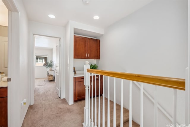 hall featuring light colored carpet