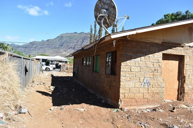 view of property exterior with a mountain view