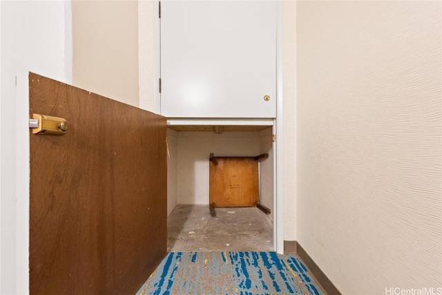 hallway with concrete flooring