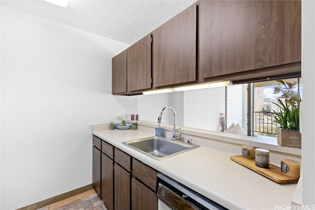 kitchen featuring a textured ceiling, dishwasher, dark brown cabinets, and sink