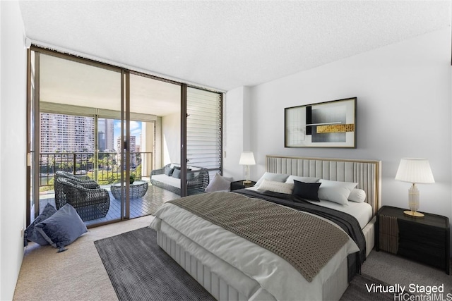 carpeted bedroom featuring access to exterior, expansive windows, and a textured ceiling