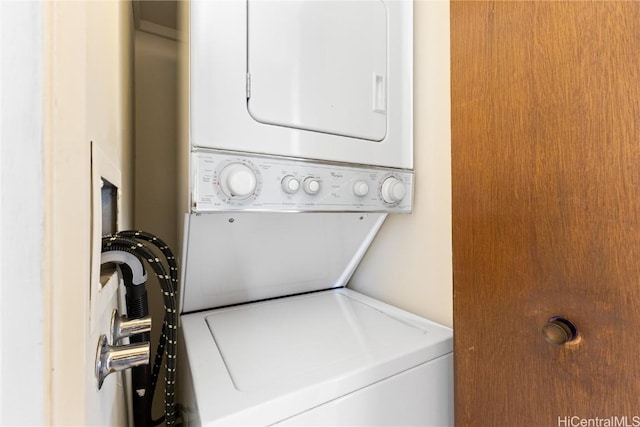 laundry area with stacked washing maching and dryer