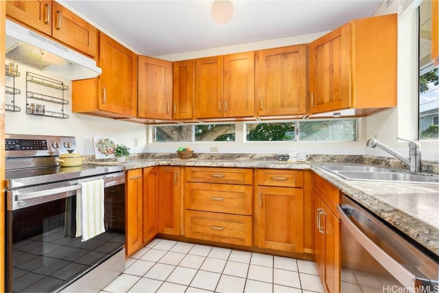 kitchen featuring appliances with stainless steel finishes, light tile patterned floors, and sink