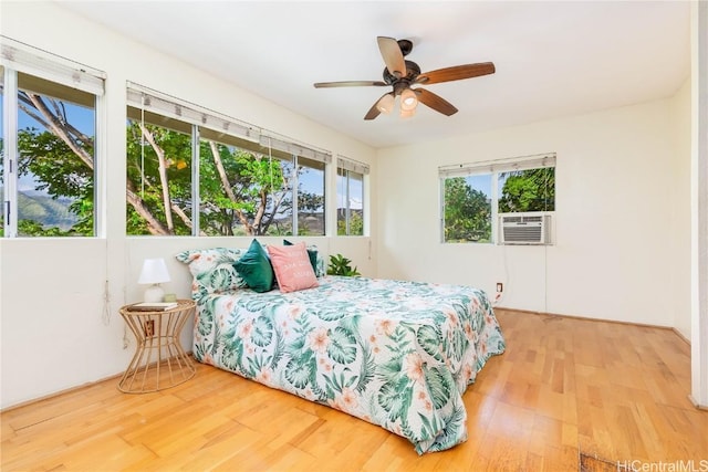 bedroom with hardwood / wood-style flooring and ceiling fan