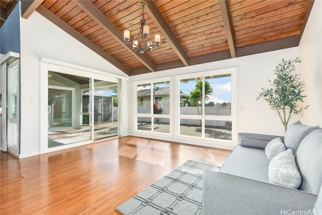 unfurnished sunroom with vaulted ceiling with beams, wood ceiling, and an inviting chandelier