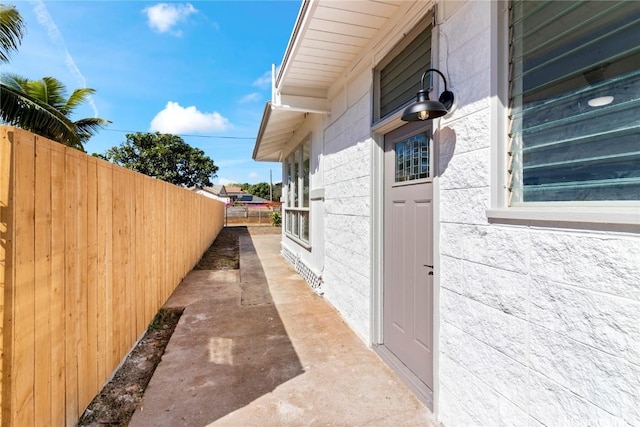 view of home's exterior with stucco siding and fence