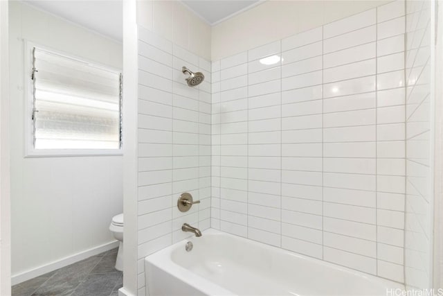 bathroom featuring tile patterned floors, toilet, baseboards, and shower / washtub combination