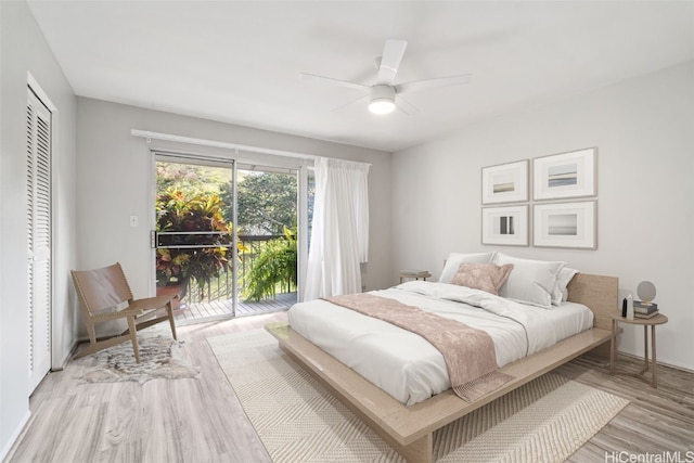 bedroom featuring access to outside, a closet, light wood-style flooring, and a ceiling fan