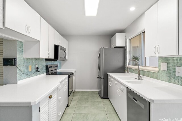 kitchen with backsplash, sink, white cabinets, and stainless steel appliances