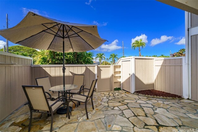 view of patio featuring a storage shed