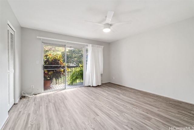 empty room with ceiling fan and light hardwood / wood-style floors