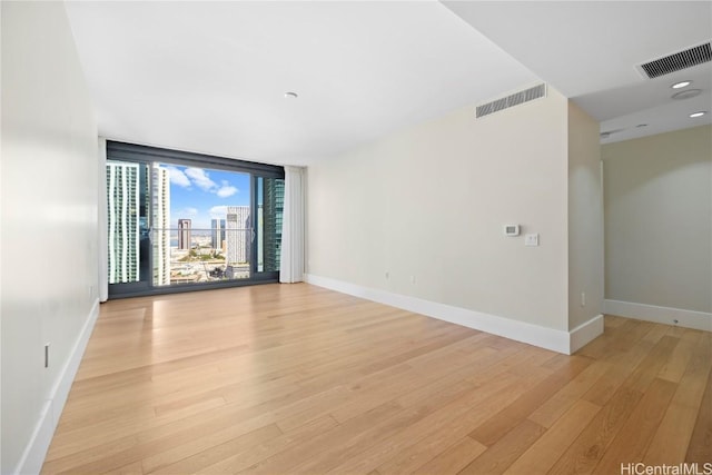 spare room featuring light wood-type flooring