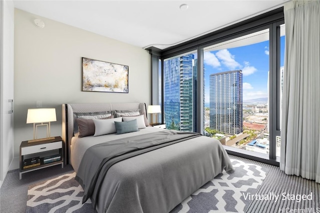 bedroom with floor to ceiling windows, access to exterior, and carpet floors