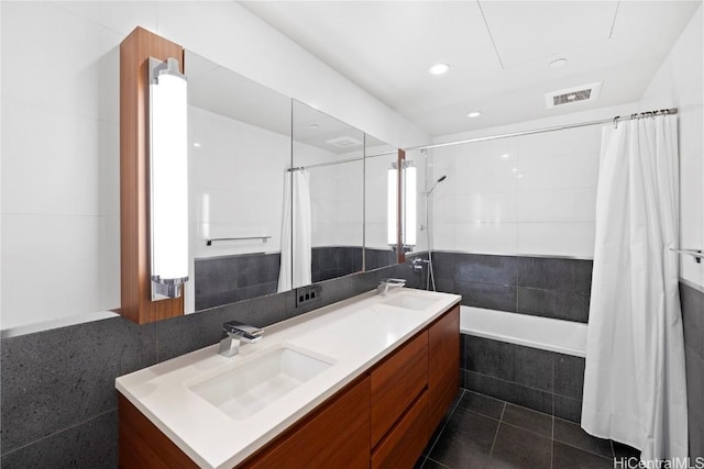 bathroom with tile patterned floors, vanity, tile walls, and shower / tub combo with curtain