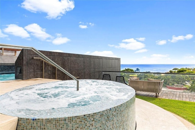 view of patio featuring pool water feature and a water view