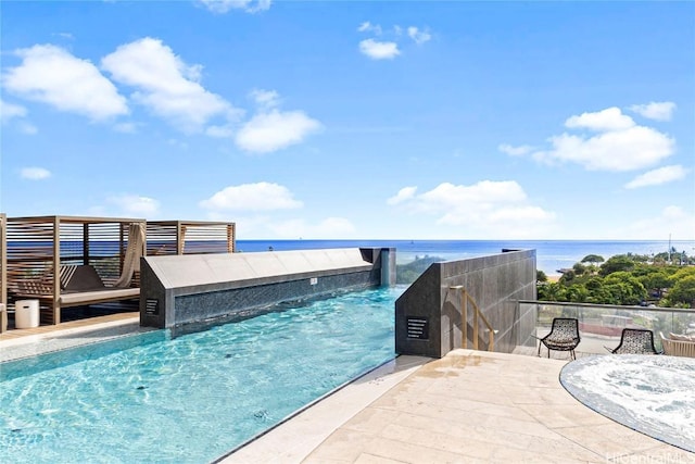 view of pool featuring a water view and a patio area