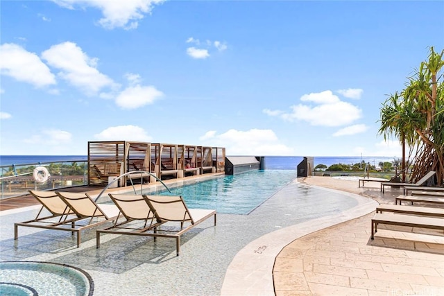 view of swimming pool with a water view