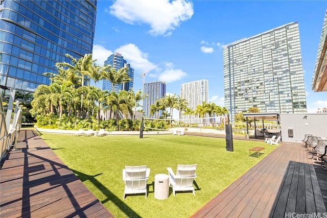 view of home's community with a lawn and a wooden deck