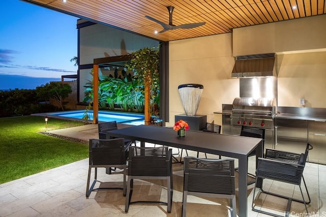 patio terrace at dusk featuring a lawn, area for grilling, and ceiling fan