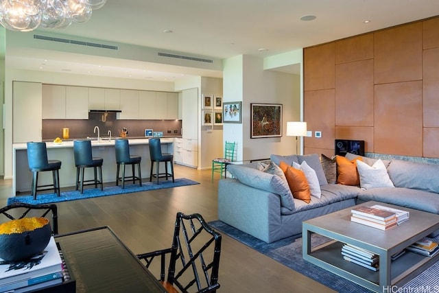 living room with dark wood-type flooring and sink