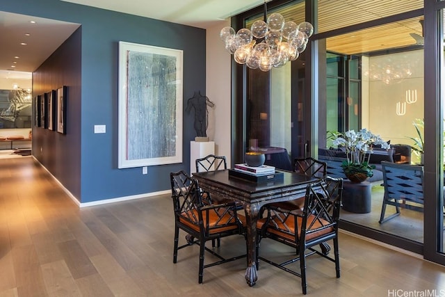 dining space with a notable chandelier and wood-type flooring