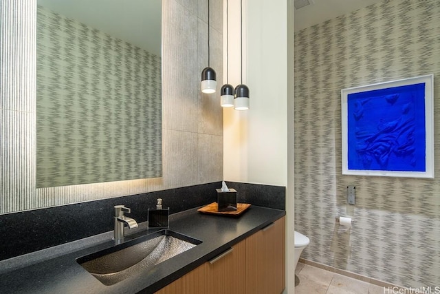 bathroom with tile patterned flooring, vanity, and toilet