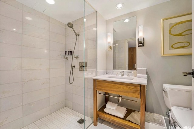 bathroom with vanity, toilet, and a shower with shower door