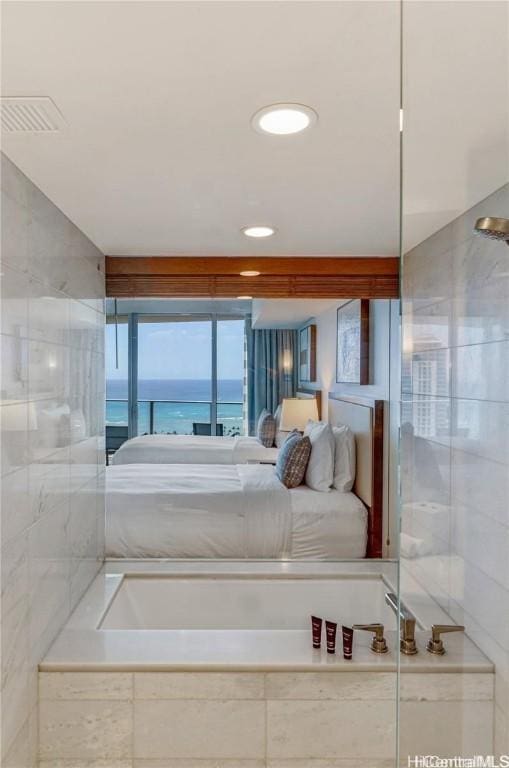 bedroom featuring a water view